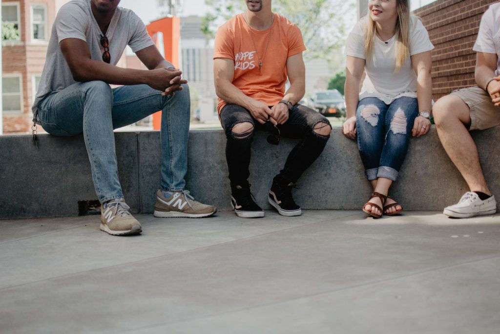 Group of friends sitting on cement bench