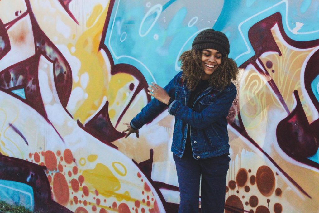 Woman standing in front of grafitti