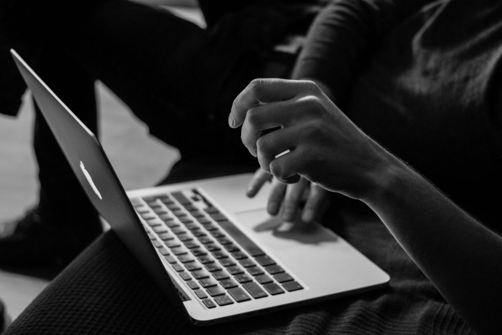 Hands typing on keyboard close up